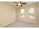 Carpeted bedroom features a ceiling fan, two windows, and neutral wall color at 18711 Ruffner Dr # 1A, Cornelius, NC 28031