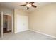 Bedroom featuring carpet, a ceiling fan, and closet for ample storage at 18711 Ruffner Dr # 1A, Cornelius, NC 28031
