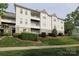 Attractive condo building featuring multiple balconies, manicured landscaping, and architectural detail at 18711 Ruffner Dr # 1A, Cornelius, NC 28031