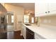 Kitchen features stainless steel appliances, white cabinets, and a breakfast bar overlooking living room at 18711 Ruffner Dr # 1A, Cornelius, NC 28031