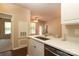 Bright kitchen features stainless appliances, white cabinets, and quartz countertop bar open to the living area at 18711 Ruffner Dr # 1A, Cornelius, NC 28031