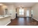 Open-concept living space with wood floors, a fireplace, and access to a balcony at 18711 Ruffner Dr # 1A, Cornelius, NC 28031