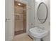Bathroom featuring pedestal sink and tiled walk in shower with glass door at 1949 S Wendover Rd, Charlotte, NC 28211