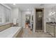 Bathroom boasts soaking tub, glass-enclosed shower with tile surround, and access to main bedroom at 1949 S Wendover Rd, Charlotte, NC 28211