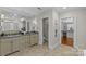 Bathroom boasts a double sink vanity with granite countertops, tile flooring, and walk-in closet at 1949 S Wendover Rd, Charlotte, NC 28211