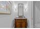 Elegant powder room features a unique vanity with marble countertop and vintage fixtures at 1949 S Wendover Rd, Charlotte, NC 28211