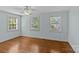 Bedroom with hardwood floors, ceiling fan and multiple windows creating a bright living space at 1949 S Wendover Rd, Charlotte, NC 28211