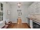 Functional butler's pantry area with built-in cabinetry, wine cooler and hardwood floors at 1949 S Wendover Rd, Charlotte, NC 28211