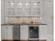 Bright and stylish butler's pantry boasts glass-front cabinets, a wine fridge, and ample counter space at 1949 S Wendover Rd, Charlotte, NC 28211