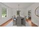 Elegant dining room with a chandelier and ample natural light from the surrounding windows at 1949 S Wendover Rd, Charlotte, NC 28211