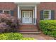 Close-up of the classic brick front entrance of the home with white door and columns at 1949 S Wendover Rd, Charlotte, NC 28211