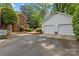 Detached two-car garage, adjacent to a brick home with meticulous landscaping at 1949 S Wendover Rd, Charlotte, NC 28211