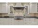 Gourmet kitchen boasting a Wolf range, custom cabinetry, and stylish tile backsplash at 1949 S Wendover Rd, Charlotte, NC 28211