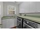 Laundry room includes modern washer and dryer, ample counter space, and natural light at 1949 S Wendover Rd, Charlotte, NC 28211