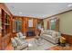 Inviting living room with wood paneling, fireplace, and abundant natural light at 1949 S Wendover Rd, Charlotte, NC 28211