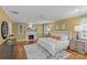 Spacious primary bedroom boasts a fireplace, plush carpet, and natural light from multiple windows at 1949 S Wendover Rd, Charlotte, NC 28211