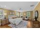 Bright and airy primary bedroom is enhanced by neutral paint, decorative rug, and large picture window at 1949 S Wendover Rd, Charlotte, NC 28211