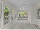 Sun-drenched sunroom with multiple windows, and a ceiling fan at 1949 S Wendover Rd, Charlotte, NC 28211