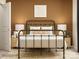 Inviting bedroom boasts a wrought iron bed frame with bedside tables and stylish decor at 2112 Columbidae Ln, Gastonia, NC 28052