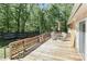 Back deck features an umbrella-covered table and chairs with views of mature trees and landscaping at 212 Davies Cir, Cleveland, NC 27013