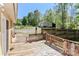 Deck overlooks a well-kept backyard with lush trees and a detached garage in the background at 212 Davies Cir, Cleveland, NC 27013