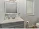 Bright bathroom featuring a gray vanity and a large, well-lit mirror at 212 Davies Cir, Cleveland, NC 27013