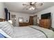 Spacious bedroom featuring wood furniture, a ceiling fan, and ample storage space at 212 Davies Cir, Cleveland, NC 27013