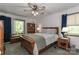 Comfortable bedroom with wood bed, ceiling fan, access to deck and ample natural light at 212 Davies Cir, Cleveland, NC 27013