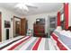 Bedroom with wood dresser, tv, and access to the closet and doorway at 212 Davies Cir, Cleveland, NC 27013