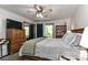 Inviting bedroom with ceiling fan, wood furniture, and access to a balcony at 212 Davies Cir, Cleveland, NC 27013