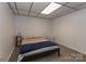 Finished basement bedroom with a simple, carpeted floor and dark-blue throw blanket at 212 Davies Cir, Cleveland, NC 27013