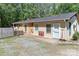 Charming exterior with gravel driveway, mature trees and two front doors at 212 Davies Cir, Cleveland, NC 27013