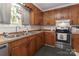 Bright kitchen features wooden cabinets, stainless steel appliances, and a double basin sink at 212 Davies Cir, Cleveland, NC 27013