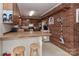 Cozy kitchen features butcher block countertops, wood cabinets, and a unique brick accent wall at 212 Davies Cir, Cleveland, NC 27013