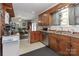 Well-lit kitchen featuring wood cabinets, stainless steel dishwasher, and a view into the dining area at 212 Davies Cir, Cleveland, NC 27013