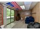 Comfortable living room with brick feature, a large sliding glass door and overhead American flag at 212 Davies Cir, Cleveland, NC 27013