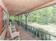 Spacious covered porch with rocking chairs, perfect for enjoying the serene outdoor views at 212 Davies Cir, Cleveland, NC 27013