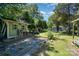 View of the backyard featuring a shed, mature trees, and greenery offering a private and spacious outdoor area at 2278 Jon Chris Dr, Harrisburg, NC 28075