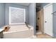 This bathroom features a soaking tub with decorative tile and a separate shower at 2278 Jon Chris Dr, Harrisburg, NC 28075
