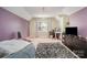 This carpeted bedroom features neutral paint, a chandelier, and a large window at 2278 Jon Chris Dr, Harrisburg, NC 28075
