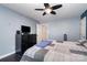 The bedroom with hardwood floors features a ceiling fan and a dark dresser at 2278 Jon Chris Dr, Harrisburg, NC 28075