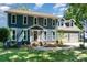 Beautiful two-story home with a manicured lawn, complemented by a driveway and a two-car garage at 2278 Jon Chris Dr, Harrisburg, NC 28075