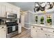 Bright kitchen featuring granite countertops, stainless steel appliances and a hanging pot rack at 2278 Jon Chris Dr, Harrisburg, NC 28075