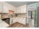 Well-maintained kitchen with white cabinetry, stainless steel appliances, and decorative backsplash at 2278 Jon Chris Dr, Harrisburg, NC 28075