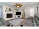 Inviting living room featuring a fireplace, a ceiling fan, and comfortable leather seating at 2278 Jon Chris Dr, Harrisburg, NC 28075