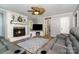 Inviting living room featuring a fireplace, a ceiling fan, and comfortable leather seating at 2278 Jon Chris Dr, Harrisburg, NC 28075