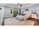 Spacious bedroom featuring hardwood floors, tray ceiling, and windows at 2278 Jon Chris Dr, Harrisburg, NC 28075