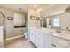 Bright bathroom features dual vanities, a large mirror, and a tiled shower with glass door at 247 Tackle Box Dr, Troutman, NC 28166