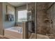 Modern bathroom showcases a soaking tub, separate tiled shower, and natural light at 247 Tackle Box Dr, Troutman, NC 28166