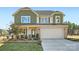 Charming two-story home with a stone-accented facade, two-car garage, and well-maintained landscaping at 247 Tackle Box Dr, Troutman, NC 28166